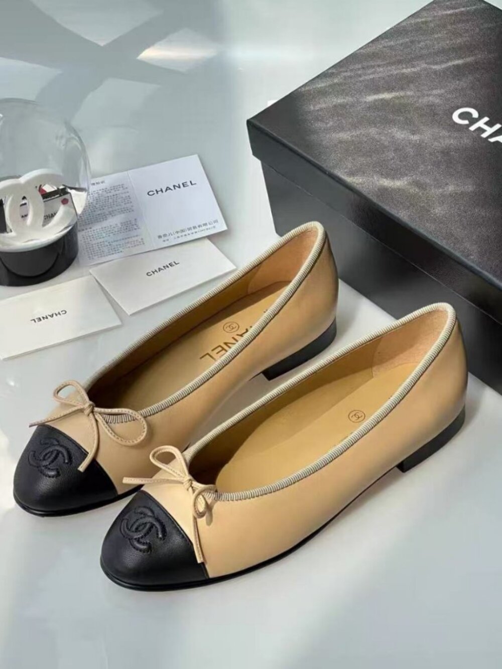 CHANEL Ballet Flats, Beige‑Black Two‑Tone Leather With Front Bow Decoration
